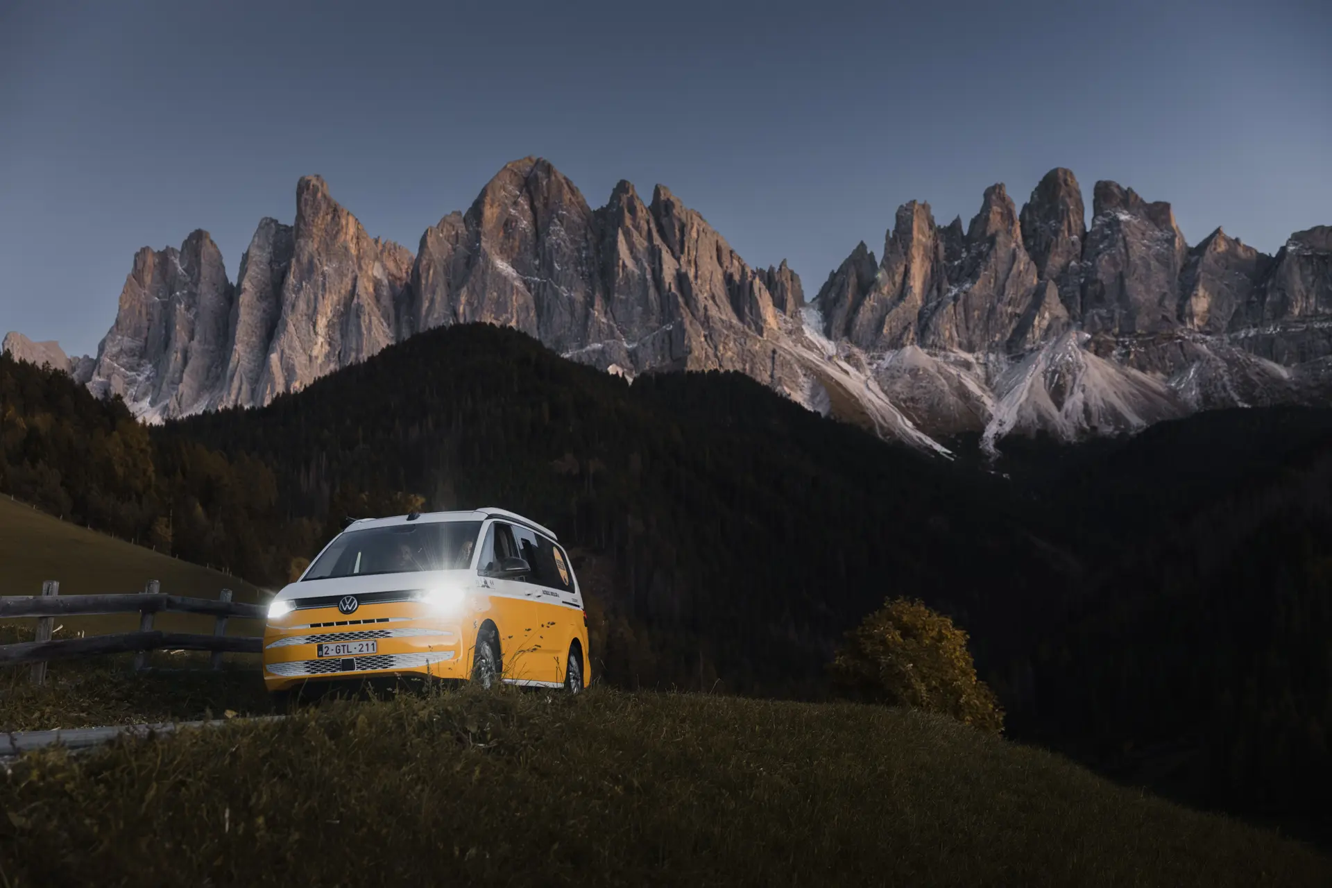 A campervan with a mountain backdrop