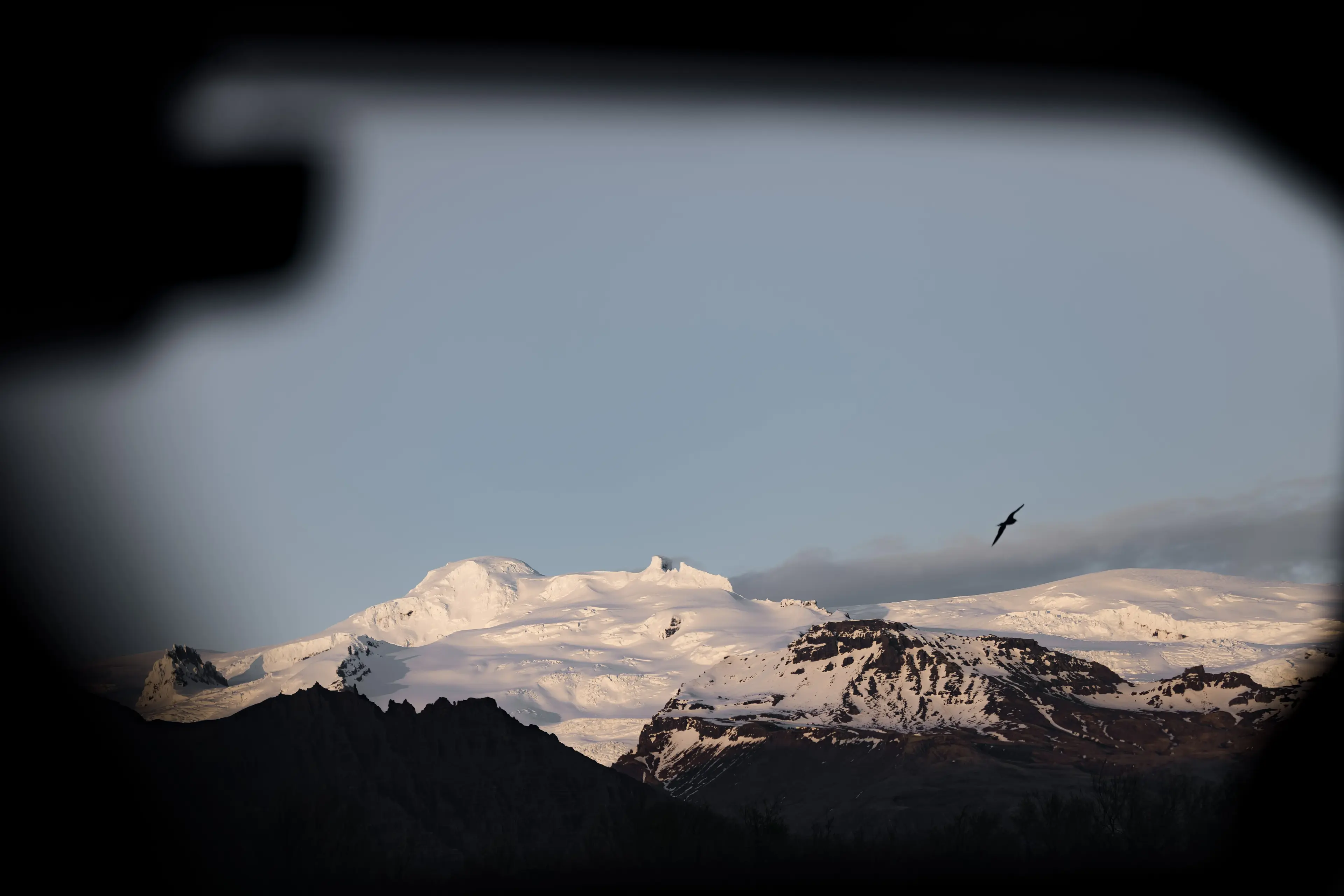 A mountain view in snow from a Jeep